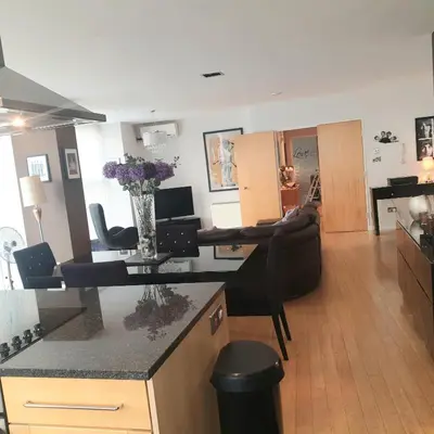 a kitchen and living room with a table and chairs at Luxury Apartment Best location in Liverpool city center in Liverpool