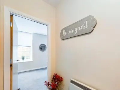 a sign that reads be our guest on a wall at Magnificent 1BDR Apartment in Mersyside in Liverpool