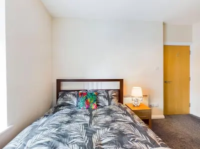 a bedroom with a bed with a colorful comforter at Magnificent 1BDR Apartment in Mersyside in Liverpool