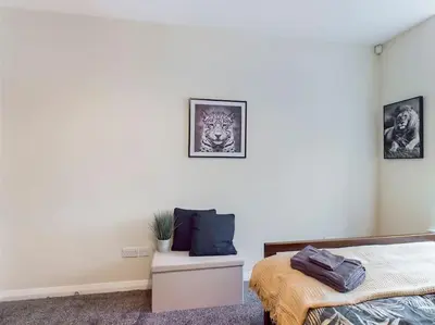a bedroom with a bed and a table with a pillow at Magnificent 1BDR Apartment in Mersyside in Liverpool