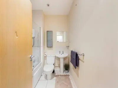 a bathroom with a toilet and a sink at Magnificent 1BDR Apartment in Mersyside in Liverpool