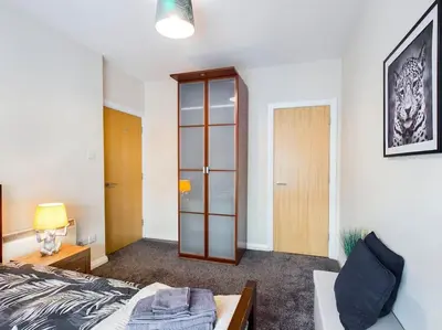 a bedroom with a bed and a glass cabinet at Magnificent 1BDR Apartment in Mersyside in Liverpool