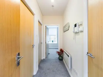 a hallway of a hospital room with a door and a hallway at Magnificent 1BDR Apartment in Mersyside in Liverpool