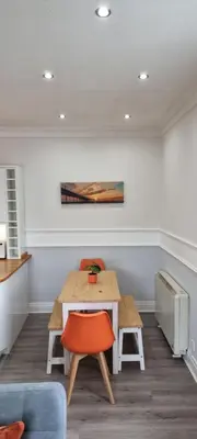 a dining room with a table and two chairs at Lakeview Apartment, central location, Sea and Lake view, free parking & WiFi in Southport
