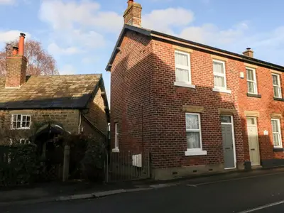 an old brick house on the side of a street at Myrtle Cottage in Preston