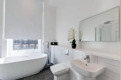 a white bathroom with a toilet and a sink at 80 by Elite in Liverpool