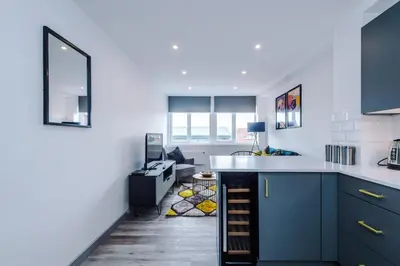 a kitchen with blue cabinets and a counter top at Charles House by Guestz in Preston