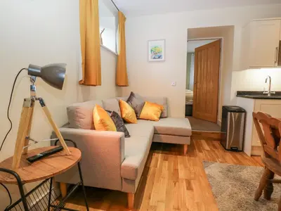 a living room with a couch and a table at Granary in Ulverston