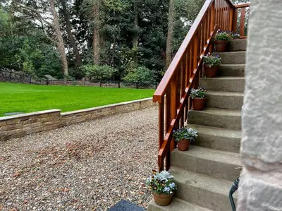 a set of stairs with potted plants on them at Cosy Alpine Cottage in the heart of Lancashire in Catterall