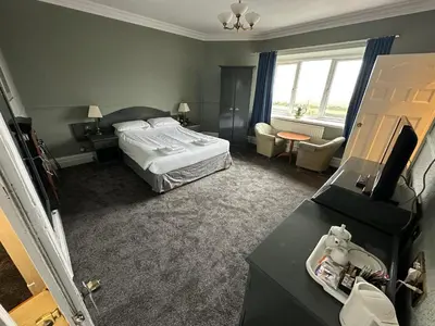 a hotel room with a bed and a desk at Clarkes Hotel Barrow in Furness in Barrow in Furness