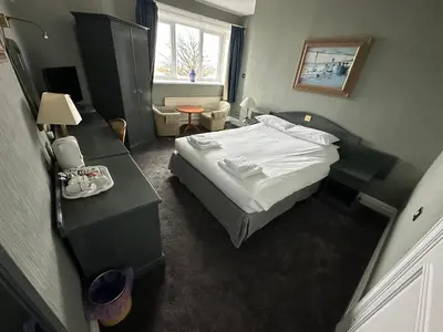 a small room with a bed and a table at Clarkes Hotel Barrow in Furness in Barrow in Furness