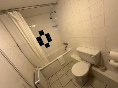 a bathroom with a toilet and a shower and a tub at Clarkes Hotel Barrow in Furness in Barrow in Furness