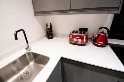 a kitchen counter with a sink and a toaster at Winter Gardens Suites by Sasco in Blackpool