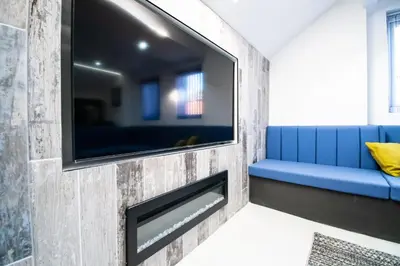 a living room with a flat screen tv on a wall at Winter Gardens Suites by Sasco in Blackpool
