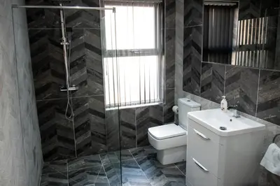 a bathroom with a toilet and a sink and a shower at Winter Gardens Suites by Sasco in Blackpool