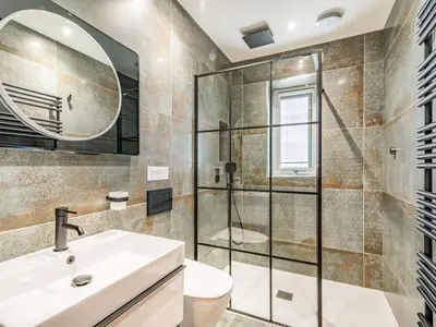 a bathroom with a shower and a sink and a toilet at Mya Cottage in Wilpshire