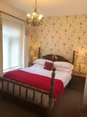 a bedroom with a large bed with a red blanket at Edenfield Number 42 in Blackpool