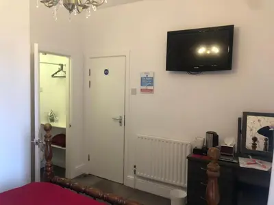 a bedroom with a television on the wall and a door at Edenfield Number 42 in Blackpool