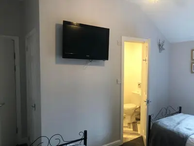 a flat screen tv on the wall of a bedroom at Edenfield Number 42 in Blackpool