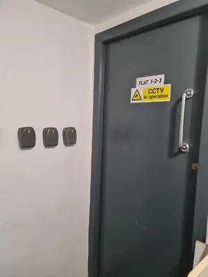 a door with a sign on it in a room at Town Centre Maisonette in Ulverston