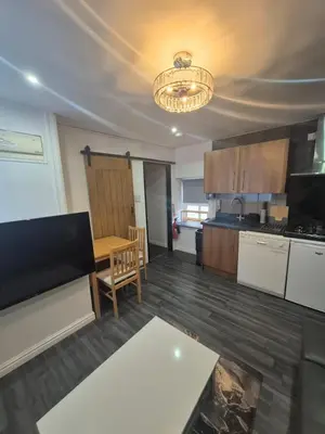 a kitchen with a table and a dining room at Town Centre Maisonette in Ulverston