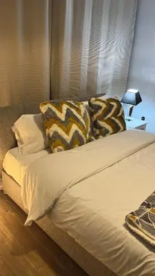 a bed with two pillows on top of it at Moorfield Liverpool City Studios in Liverpool