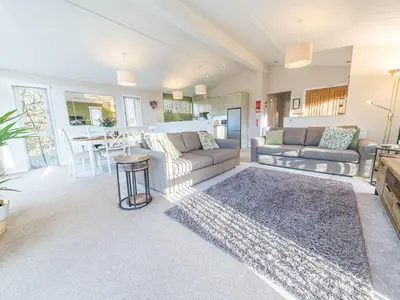 a living room with a couch and a table at Fern Lodge in Grange Over Sands
