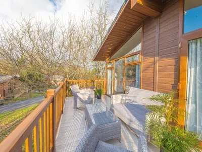 a deck with benches on a house at Fern Lodge in Grange Over Sands