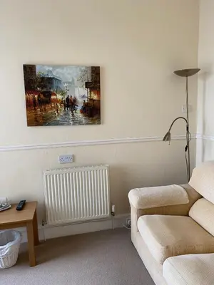 a living room with a couch and a painting on the wall at The Laurels in Blackpool