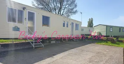 a house with a sign that reads backyard camper conversion at Becky's Caravan at Marton Mere in Blackpool