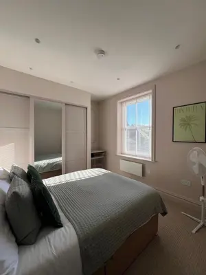 a bedroom with a large bed and a window at The Apartments Lytham Square in Lytham St Annes