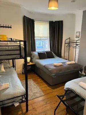 a bedroom with two bunk beds and a window at Rooms Anfield- 5 mins from LFC in Liverpool