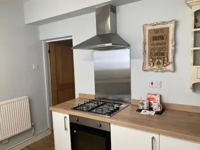 a kitchen with a stove top oven in a kitchen at Adlington Cottage, Lancashire in Adlington