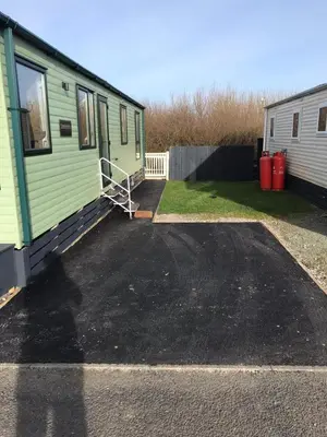 a green trailer parked in a parking lot at Tranquility - Static Caravan Lune Park on Parkdean Ocean Edge Resort in Heysham