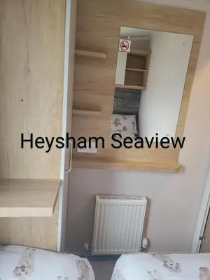 a small room with two beds and a stairway at Heysham seaview in Heysham