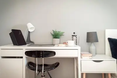 a white desk with a laptop and a black chair at Stunning Mersey View Flat w Parking in Liverpool in Liverpool