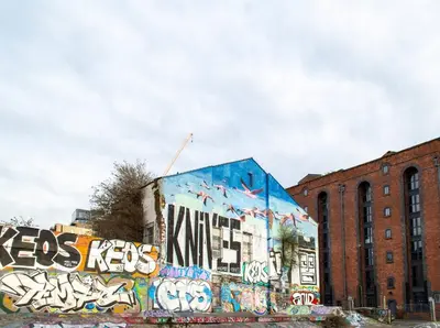 a building with graffiti on the side of it at Stunning Mersey View Flat w Parking in Liverpool in Liverpool