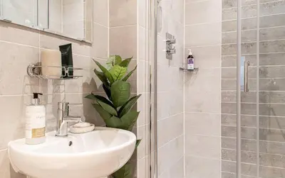 a bathroom with a sink and a shower at Stunning Mersey View Flat w Parking in Liverpool in Liverpool
