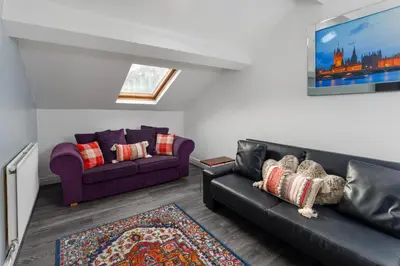 a living room with two couches and a rug at Snuggle Cove Apartments By Bella Vita Stays in Liverpool