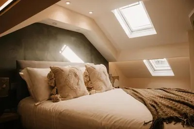 a bedroom with a large bed with skylights at The Old Brewery in Ulverston
