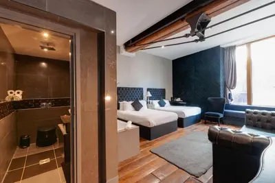 a hotel room with a bed and a couch at Boutique 56 in Liverpool