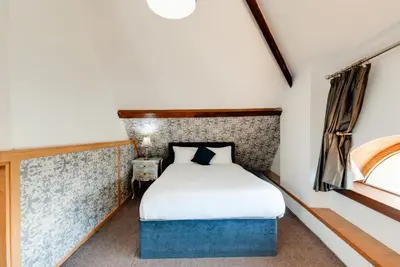 a small bedroom with a bed and a window at Boutique 56 in Liverpool