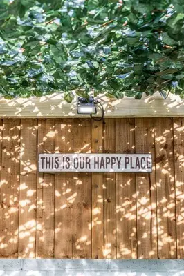 a sign on a fence that reads this is our happy place at Stunning house close to the stadium + Hot tub! in Liverpool