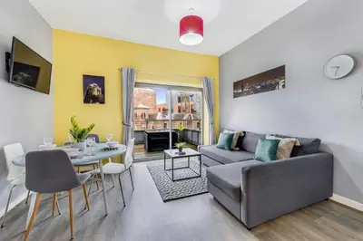 a living room with a couch and a table at Host & Stay - Campbell Square Roof Terrace Apartment in Liverpool