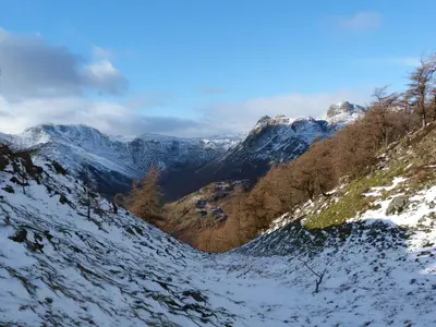 a snow covered mountain with trees and mountains at Beech in Ulverston