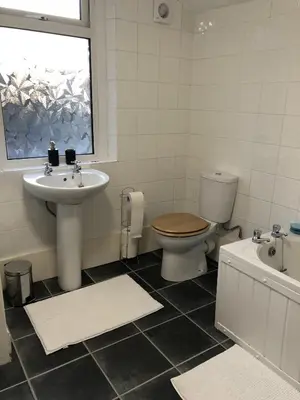 a bathroom with a sink and a toilet and a window at River Terrace in Lancaster