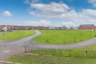 a winding road in a park with a field at Main Street Town House in Leyland