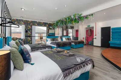 a large room with two beds and a couch at Luxury Mirror Party Pad with 4 Bedrooms! in Liverpool