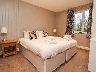 a bedroom with a bed with towels on it at Beech Lodge in Preston