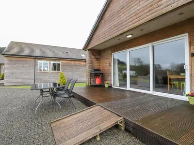 a wooden deck on the side of a house at Beech Lodge in Preston